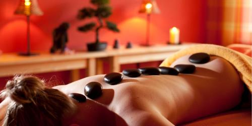 a woman laying on a bed in a red room at Schwarzwald Panorama in Bad Herrenalb
