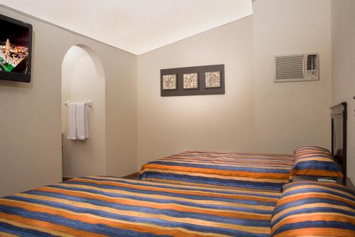 Una cama o camas en una habitación de Hotel Ibiza