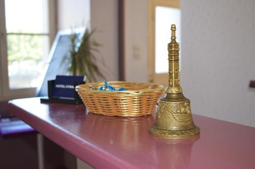 a gold object sitting on a table with a basket at Hôtel de France in Saint-Savin-sur-Gartempe