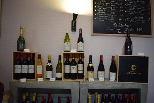 a bunch of bottles of wine sitting on a shelf at Hôtel de France in Saint-Savin-sur-Gartempe