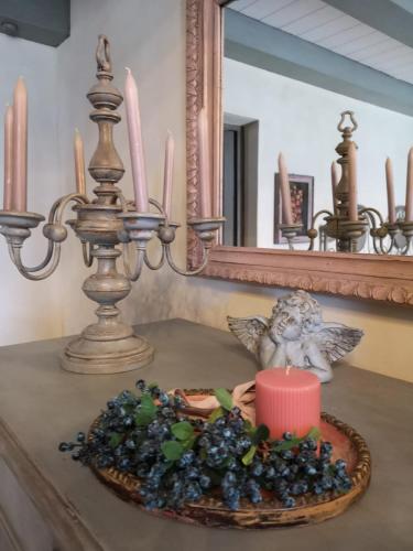 a table with a plate of grapes and a candle at B&B Col di Piagge in Gualdo Tadino