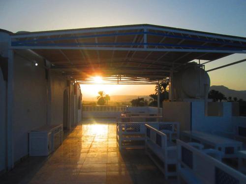 a sunset from a balcony with the sun setting at Moon Valley Apartments in Luxor