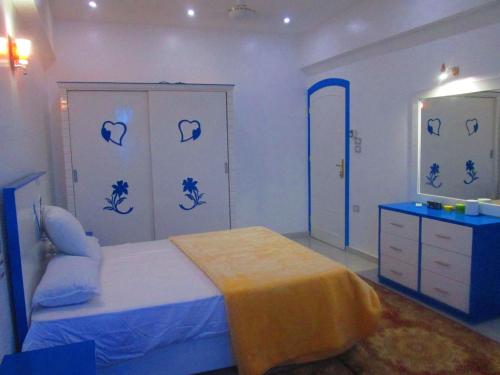 a bedroom with a bed and a dresser and a mirror at Moon Valley Apartments in Luxor