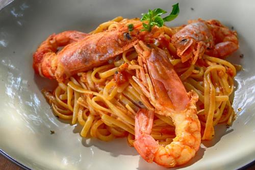 a plate of pasta with shrimp and shrimpairs at Erytha Hotel & Resort Chios in Karfas