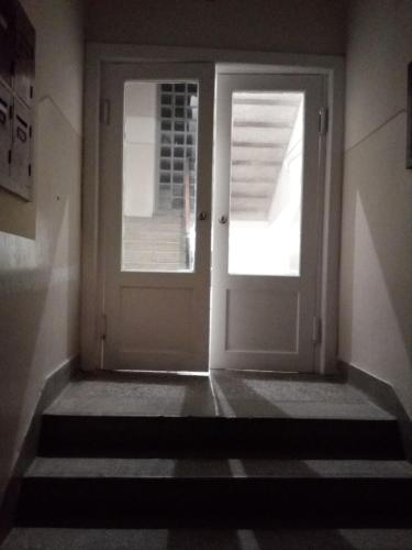 a white door in a room with stairs at HILLS Apartments in Vršac