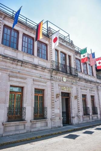 a building with flags on the front of it at Hotel Boutique Casa del Jardín Aguascalientes in Aguascalientes