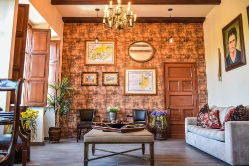 a living room with a brick wall at Hotel Boutique Casa del Jardín Aguascalientes in Aguascalientes