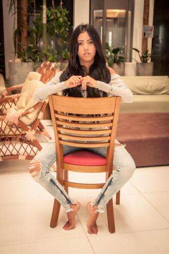 a woman sitting on a chair in a room at Matsubara Acqua Park Hotel in Maceió