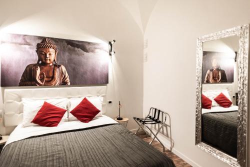a bedroom with a bed and a mirror at Trevi & Pantheon Design Rooms in Rome