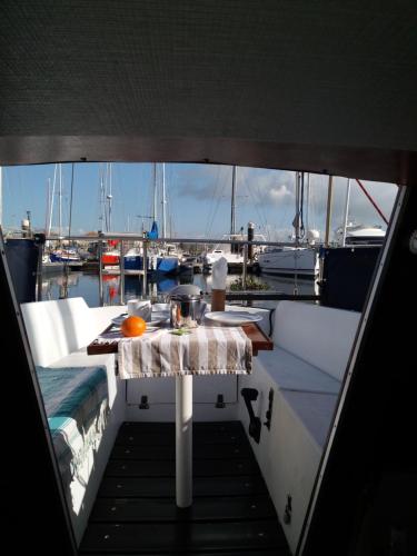 a table on a boat with a view of a marina at New Wave "The best place" in Figueira da Foz
