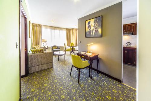 a living room with a couch and a table at Ritz Apart Hotel in La Paz