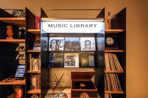 a book shelf with a music library sign on it at Kobe Motomachi Tokyu REI Hotel in Kobe
