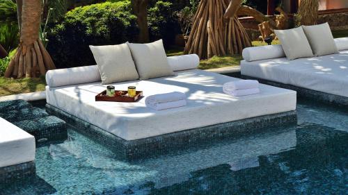 a bed sitting in the middle of a pool at Amomoxtli in Tepoztlán