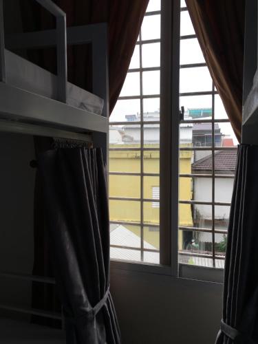 a window with a view of an airport at Maily Hostel in Hue