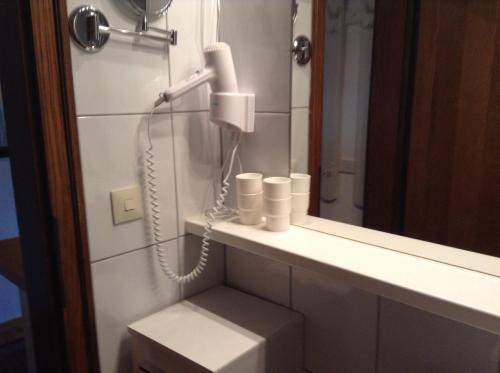 a bathroom with a phone on a counter next to a mirror at Ferienhaus Bergland in Flachau