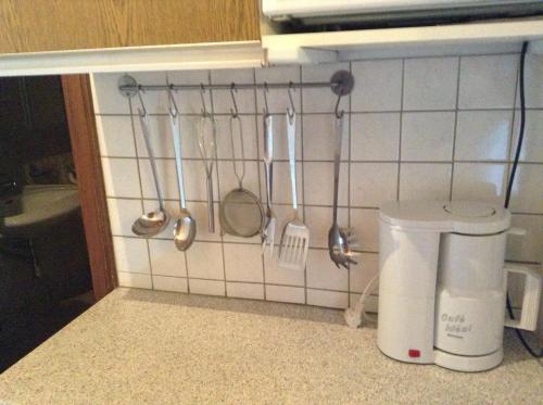 a kitchen with utensils hanging on a wall at Ferienhaus Bergland in Flachau