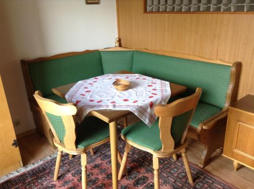 a table with two chairs and a table with a bowl on it at Ferienhaus Bergland in Flachau
