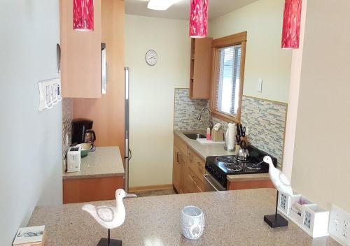 a kitchen with two white swans on the counter at The Breakers Long Beach in Long Beach