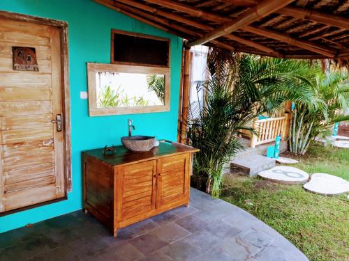 a bathroom with a sink next to a house at Gili Matiki in Gili Islands