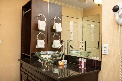 a bathroom with a bowl sink and a large mirror at Days Inn by Wyndham Concord in Concord