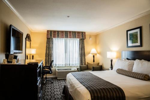 a hotel room with a bed and a window at Days Inn by Wyndham Concord in Concord