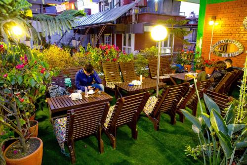 a group of people sitting at tables in a restaurant at Shangrila Boutique Hotel in Kathmandu