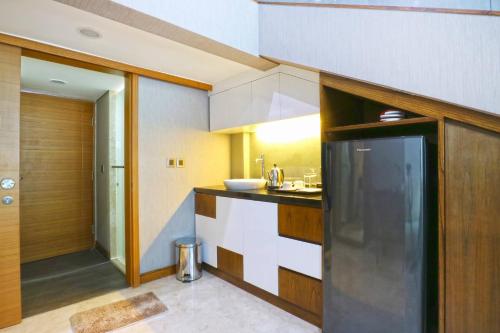 a kitchen with a sink and a counter top at The Baile in Jakarta