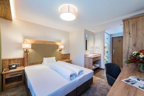 Cama o camas de una habitación en Alpensporthotel Mutterberg