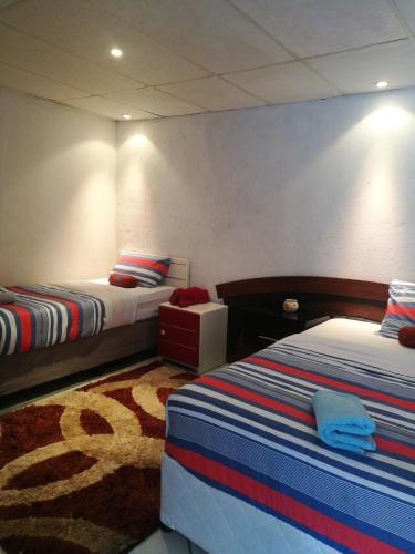 Кровать или кровати в номере Naisar Sparkling Apartment