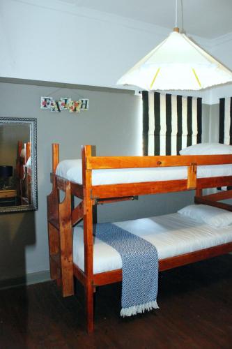 two bunk beds in a room with a mirror at Garden Route Stay in George