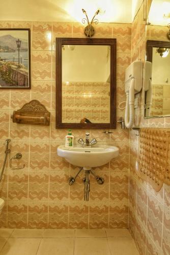 a bathroom with a sink and a mirror at Villa Samaara9 Candolim Beach in Candolim