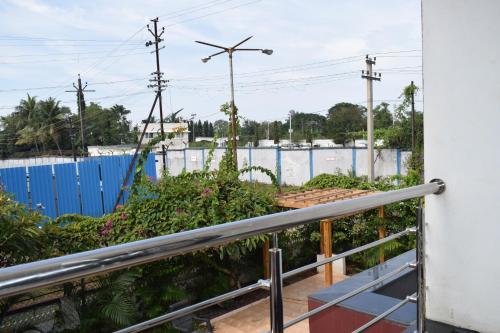 a balcony with plants and a fence at Athi Resorts in Bogmolo