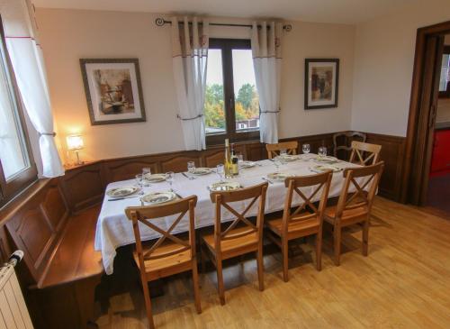 a dining room with a table and chairs and a window at Chalet Beau Regard in Hellert