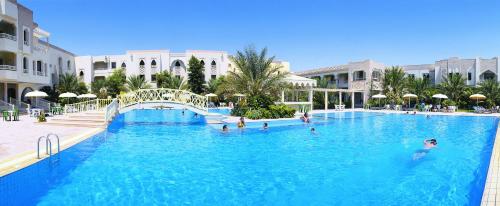 a group of people in a large swimming pool at El Mouradi Douz in Douz