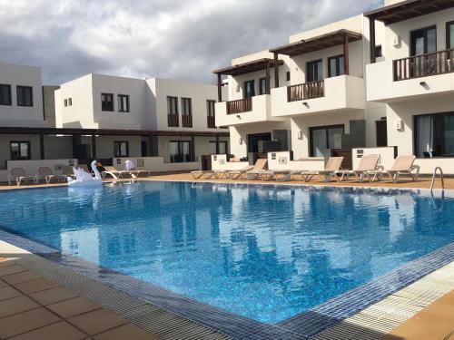a large swimming pool in front of a building at Noray Swan in Puerto Calero