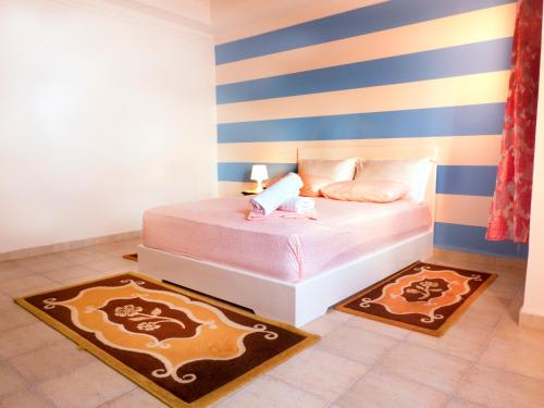 Ένα ή περισσότερα κρεβάτια σε δωμάτιο στο Chez Ali Apartments