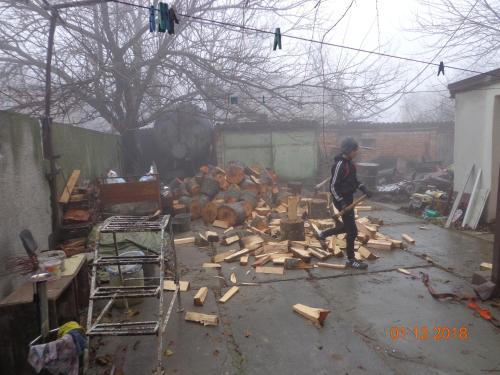 a man walking through a pile of wood at My home udabno in Udabno