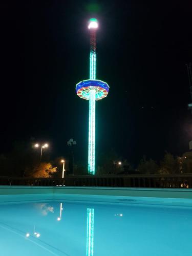 a ferris wheel lit up at night with a pool at Hotel Vittoria in Pesaro