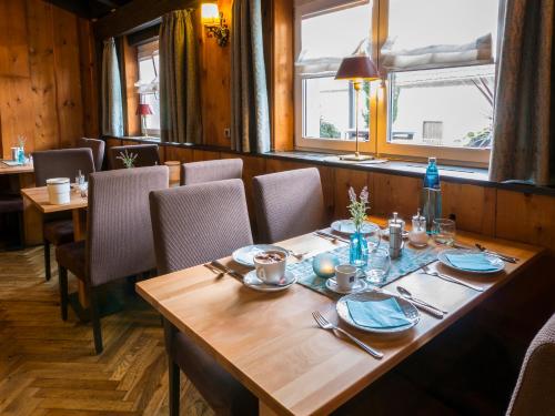 a dining room with a wooden table and chairs at Hotel Löwen Garni - B&B in Rust