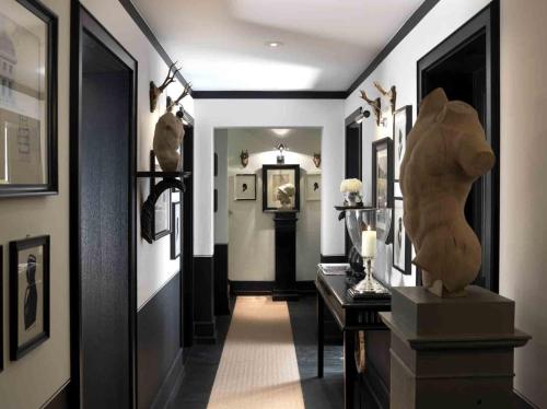 a hallway with some art on the walls at House of Hütter- Heidelberg Suites Boutique in Heidelberg