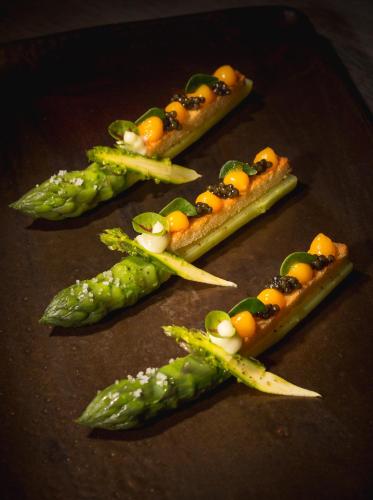 a group of asparagus and vegetables on a table at Auberge au Boeuf in Sessenheim