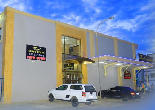 a white car parked in front of a gas station at Angel Guest House in Johannesburg