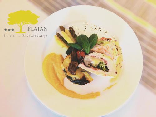 a white plate of food on a table at Hotel - Restauracja Platan in Sędziszów Małopolski