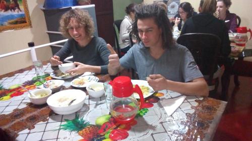 two people sitting at a table eating food at Narra Homestay in Maskeliya