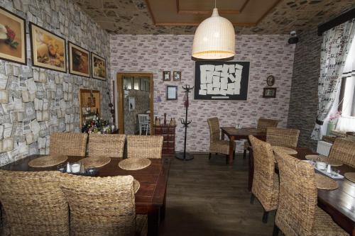 a restaurant with tables and chairs and a brick wall at Restaurace Stará Lípa in Česká Lípa