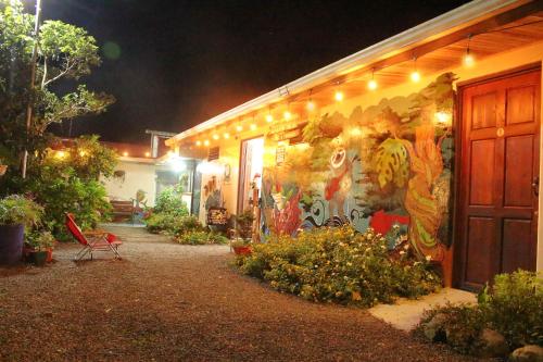 a building with a painting on the side of it at night at Casa Jungle Monteverde B&B in Monteverde Costa Rica