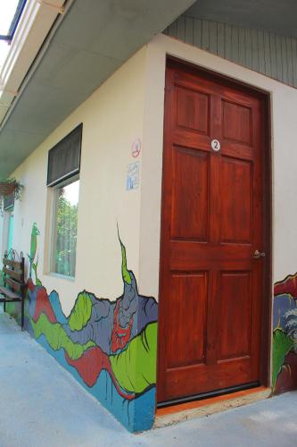 a door to a building with a painting on the side at Casa Jungle Monteverde B&B in Monteverde Costa Rica