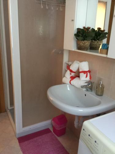 a bathroom with a sink and a shower with towels at Home Iseo Lake in Bossico