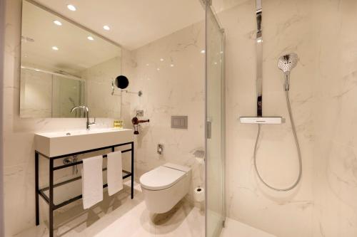 a bathroom with a shower, toilet and sink at Eurostars Madrid Gran Vía in Madrid