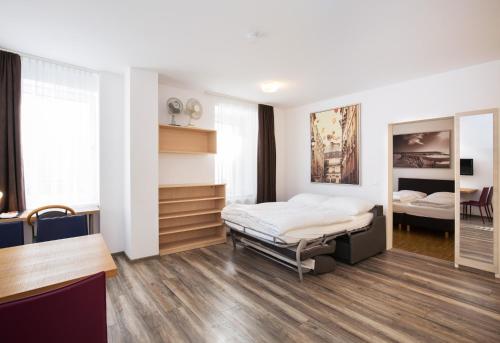 A bed or beds in a room at Apartments Leipziger Hof